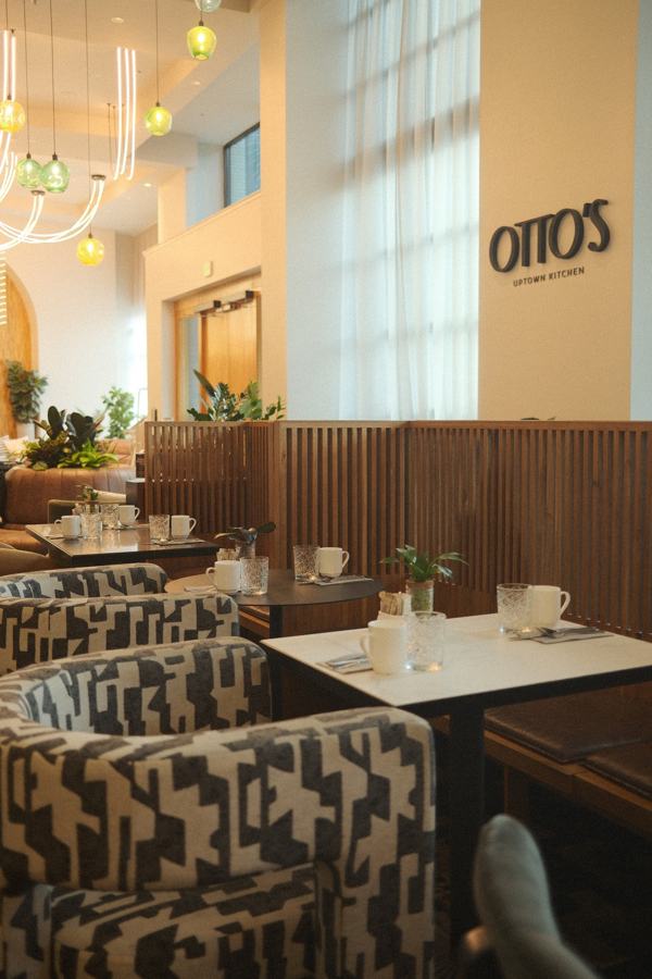 Hotel café with patterned armchairs and tall windows