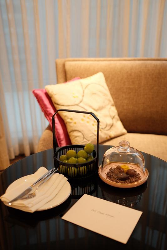 Welcome amenity on a side table beside an armchair