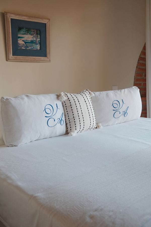 White bed with monogrammed pillows