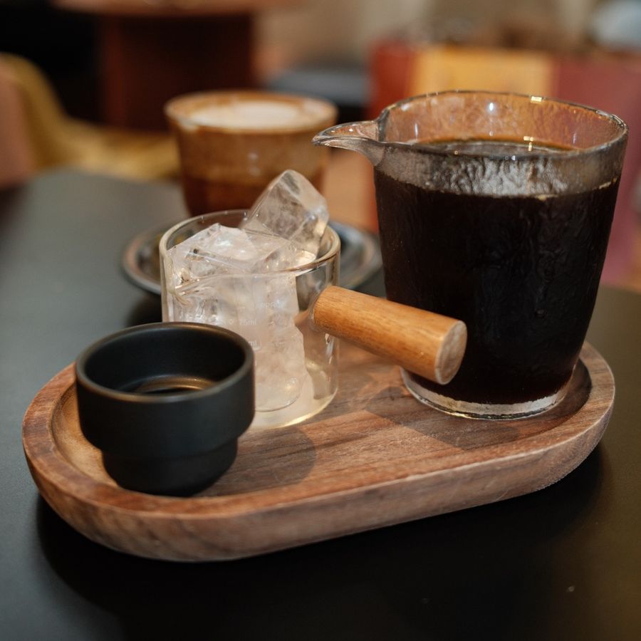 Iced coffee and espresso on a wooden tray