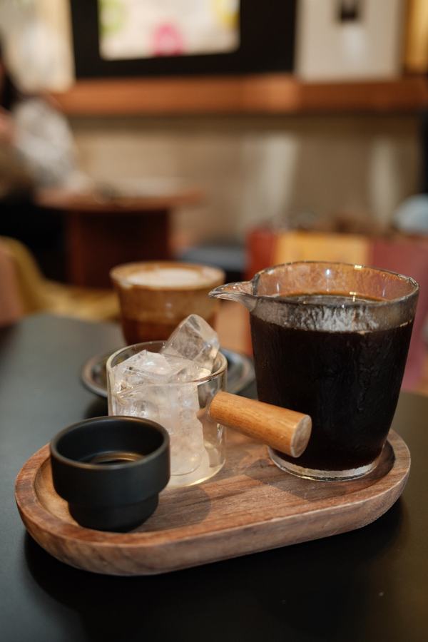 Iced coffee and espresso on a wooden tray