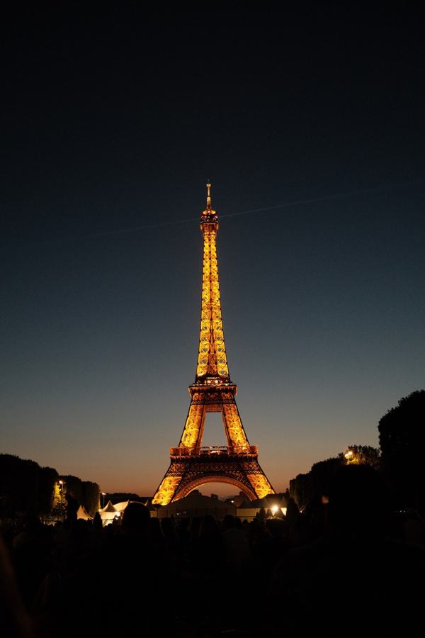 Eiffel Tower lit up at dusk