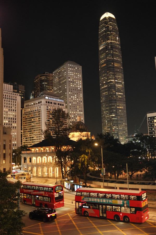 City skyline and double-decker buses at night