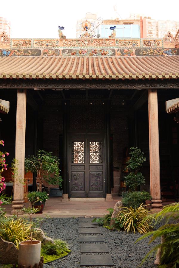 Temple courtyard with carved doors and stone path