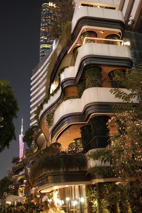 Terraced tower with hanging gardens lit at night