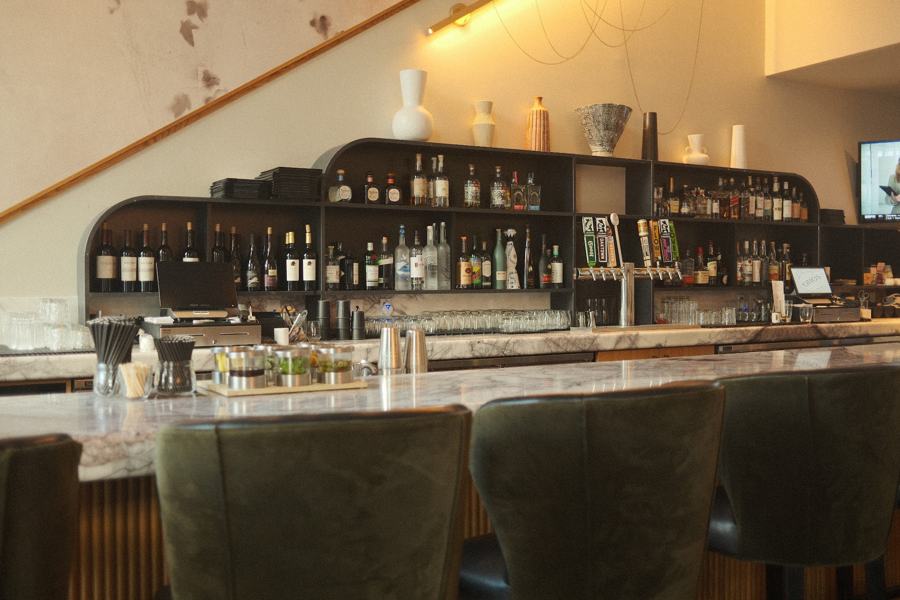 Back bar with bottles and warm shelf lighting